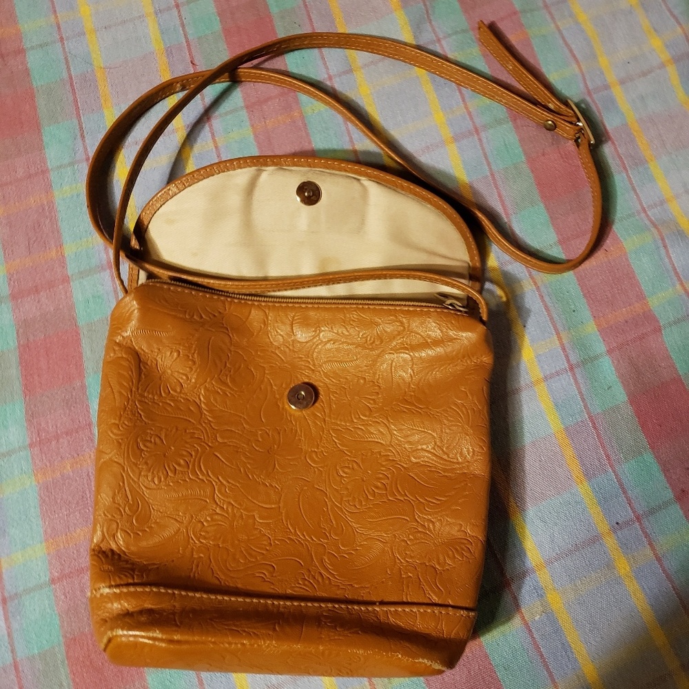 Embossed leather crossbody zip and snap purse.